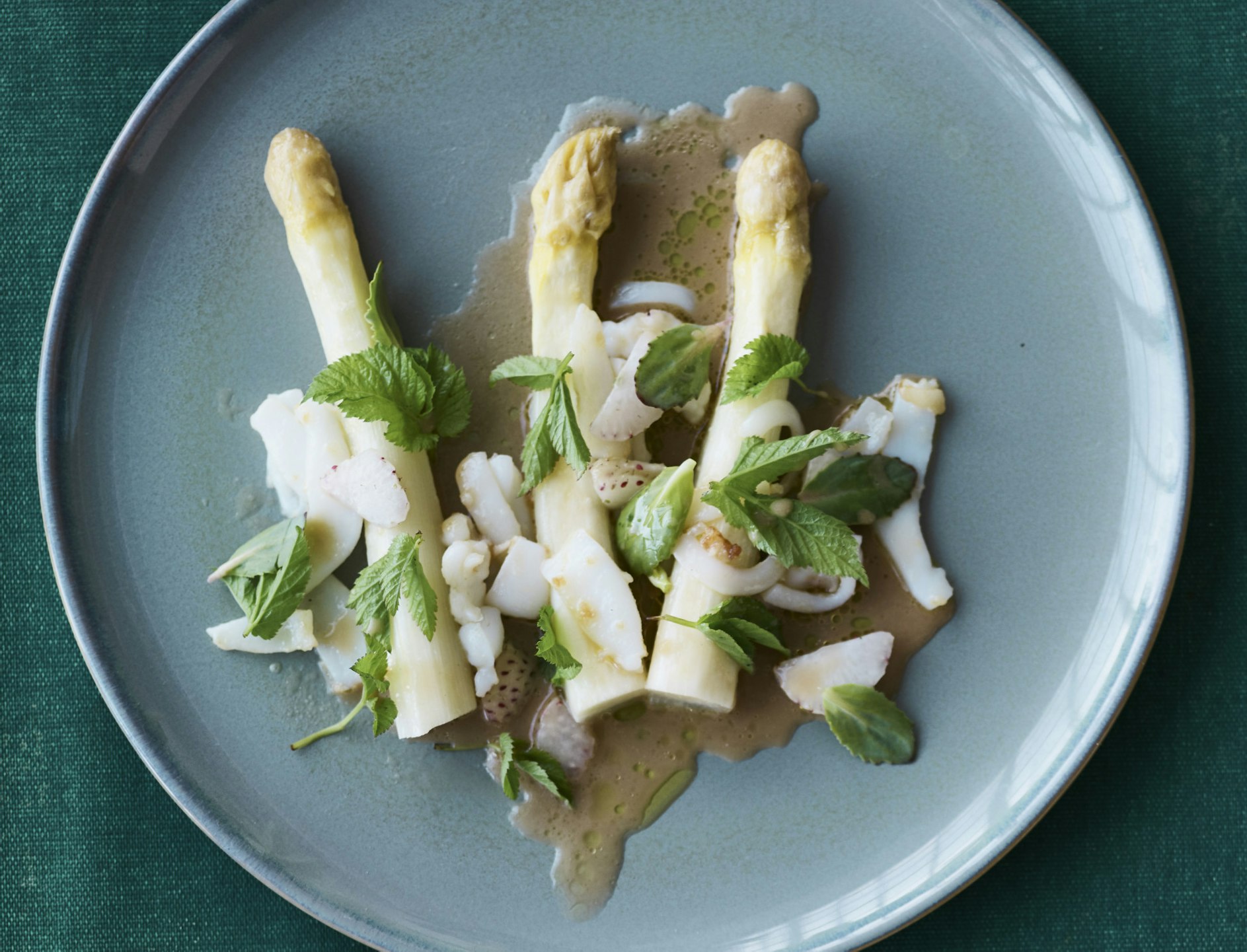 Blæksprutte med dampede hvide asparges